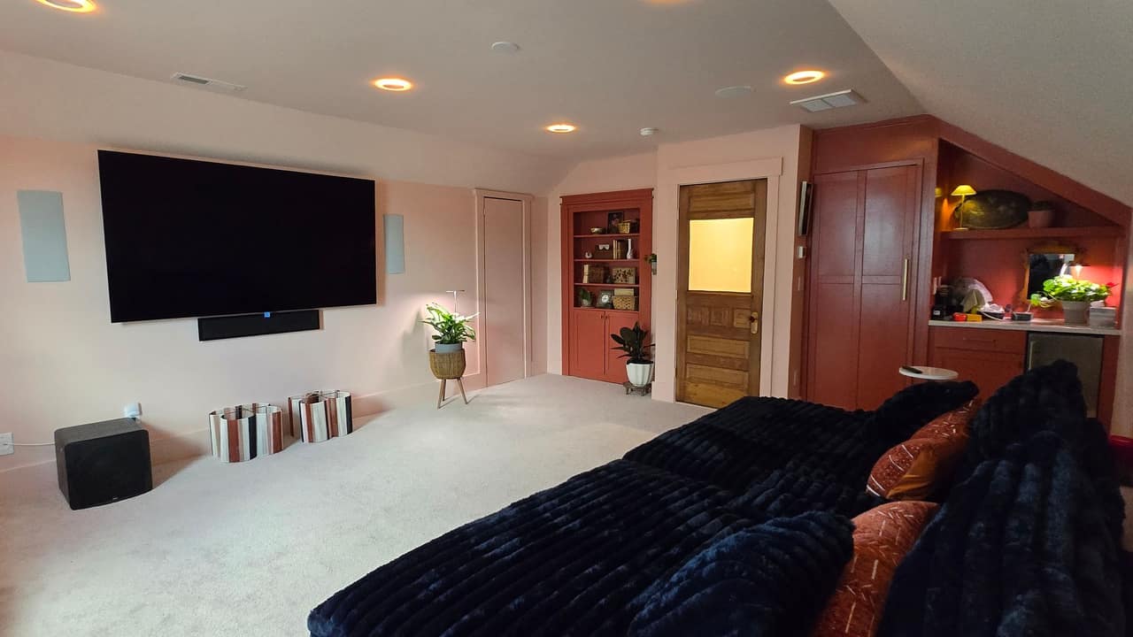 A finished bonus-room conversion by Top Line Remodel — custom built-in cabinetry, a wet bar and new recessed lighting